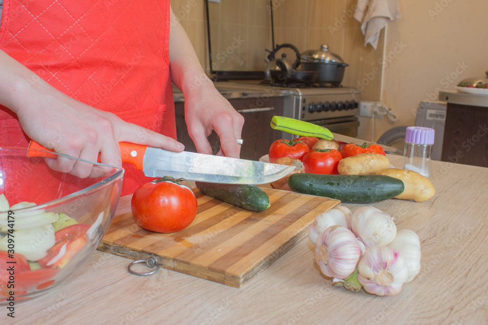 Young woman cooking healthy meal in the kitchen. Cooking healthy food. Woman in kitchen preparing vegetables Young woman cooking healthy meal in the kitchen. Cooking healthy food. Woman in kitchen preparing vegetables