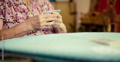 Portrait of seniors elderly old woman playing card game at lunch table at home.brain exercise with card game and alzheimer concept.