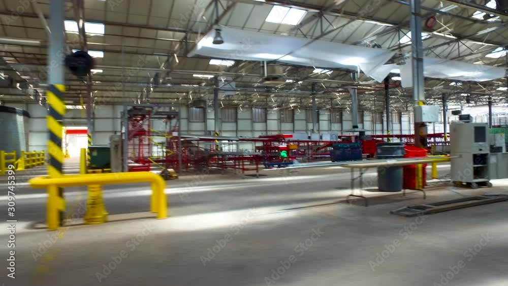 Flying inside a sorting facility. panning over a conveyor belts and machines