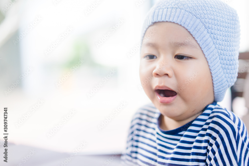 Little asian toddler boy wear hat and yawning in winter time.2 years old boy make sleepy face and tired face. Little asian toddler boy wear hat and yawning in winter time.2 years old boy make sleepy face and tired face.