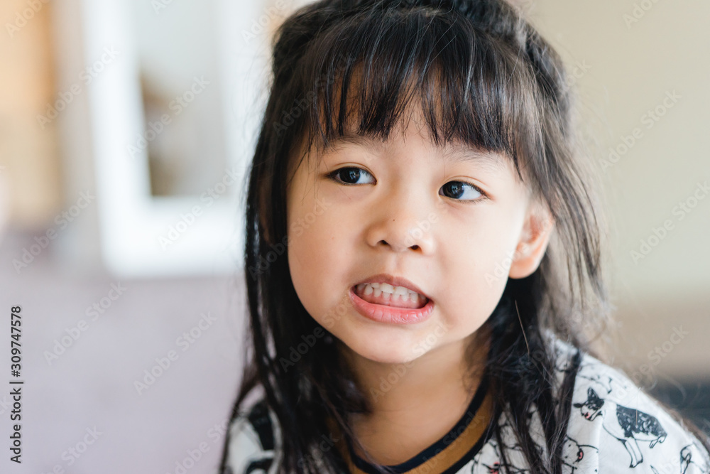 Happy little asian girl having fun face.Little asian girl child showing front teeth with big smile.Healthy happy funny smiling face kid.Joyful portrait of asian elementary school student. Happy little asian girl having fun face.Little asian girl child showing front teeth with big smile.Healthy happy funny smiling face kid.Joyful portrait of asian elementary school student.