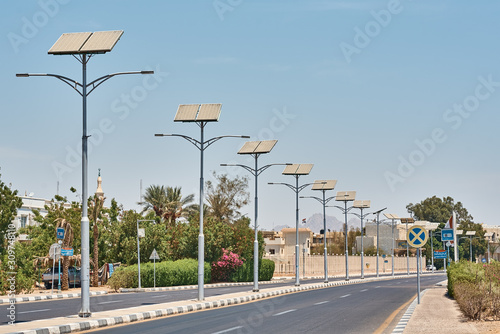 Street lamp powered with a solar panel battery against blue sky.  Alternative energy and save ecology concept