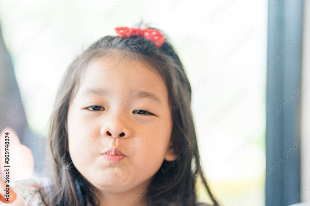 Little asian girl drinking soft drink soda in restaurant. Little asian girl drinking soft drink soda in restaurant.