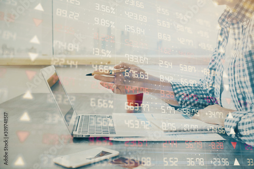 Multi exposure of stock market chart with man working on computer on background. Concept of financial analysis.