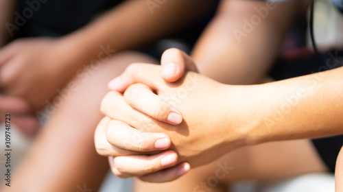 Teenager boy praying at church in the morning.teenager boy hand with faith praying Hands folded in prayer on a Holy Bible in church concept for faith  spirituality and religion