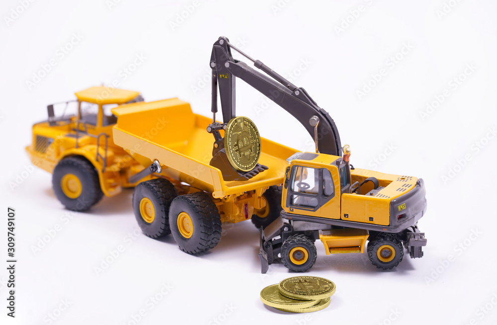 Concept of new electronic virtual money and mining cryptocurrency. Bitcoins, dollar and miniature excavator and truck