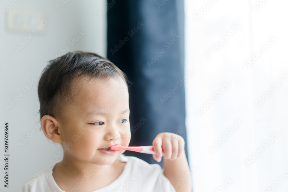 kid brushing teeth.2 years old little asian toddler boy brush teeth.dentistry and oral care concept. kid brushing teeth.2 years old little asian toddler boy brush teeth.dentistry and oral care concept.