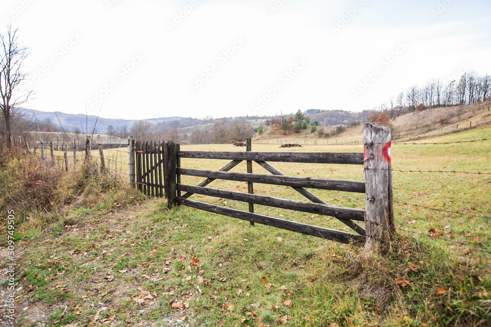 Wooden fence at farmland, autumn season, rural landscape Wooden fence at farmland, autumn season, rural landscape