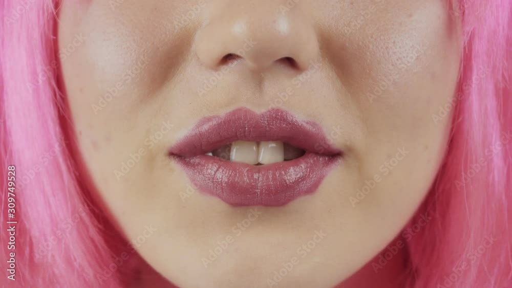 Girl with the lips of the devil. Young beautiful girl with pink hair. A new trend in cosmetology