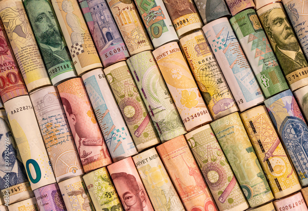 Different banknotes from various countries on rolls Different banknotes from various countries on rolls
