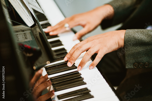 Man hands on grand piano for worship in Church.Male pianist Playing classic piano.Professional musician pianist hands on piano keys.