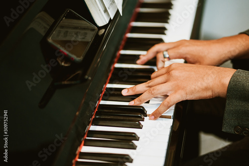 Photo Man hands on grand piano for worship in Church