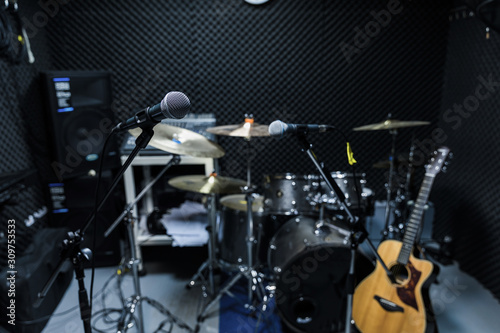 Professional condenser studio microphone, Musical Concept. recording, selective focus  microphone in radio studio, selective focus microphone and blur musical equipment guitar,