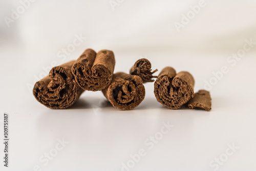 Dry cinnamon sticks closeup on white background, close-up of cinnamon rolls (Cinnamomum verum) - Image