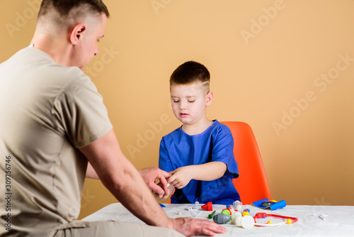 childhood. parenting. family doctor. happy child with father with stethoscope. medicine and health. father and son in medical uniform. small boy with dad play. Future career. nice to spend time.