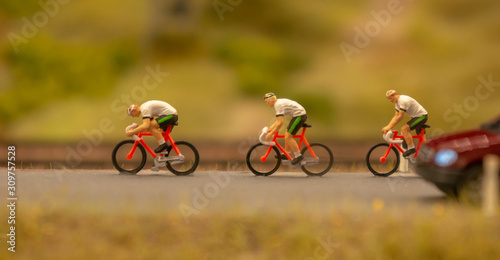 Miniature people travellers with bicycle. Travel and Sport Concept. Miniature figure of men ride bicycles