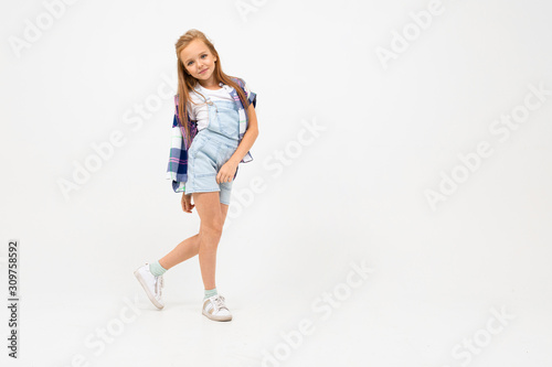 cute girl in casual look posing on a white background with copy space