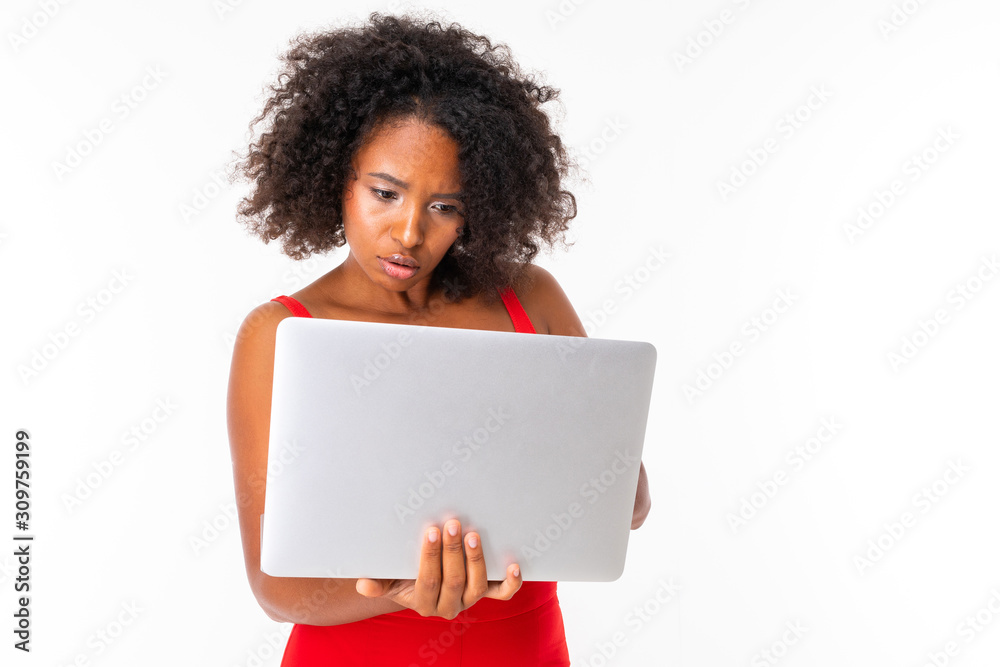 Serious african female works with laptop, picture isolated on white background Serious african female works with laptop, picture isolated on white background