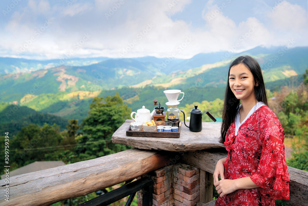 AsAsian girl relax with hot cofee and hot tea set on view point of doi sakad