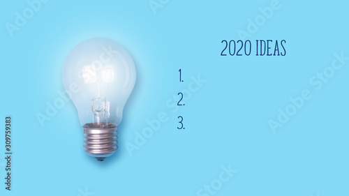 Glowing light bulb on a blue background. Concept of ideas for 2020. Copy space. Place for text. Business. Ideas.