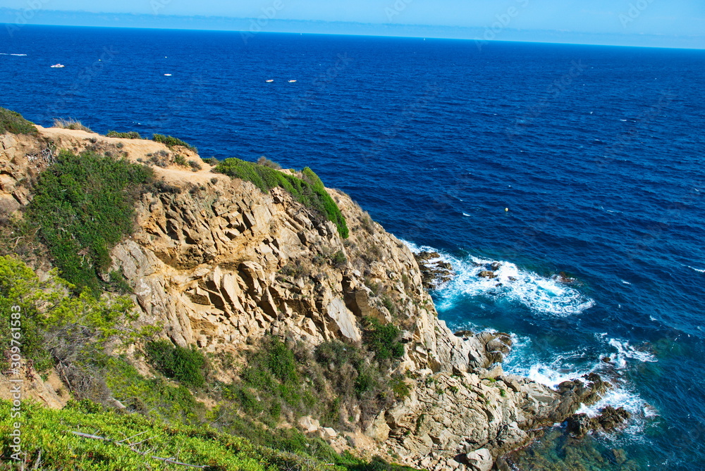Barcelona, Spain - 18.08.2019: Rocky spanish coast and blue sea in spain Barcelona, Spain - 18.08.2019: Rocky spanish coast and blue sea in spain