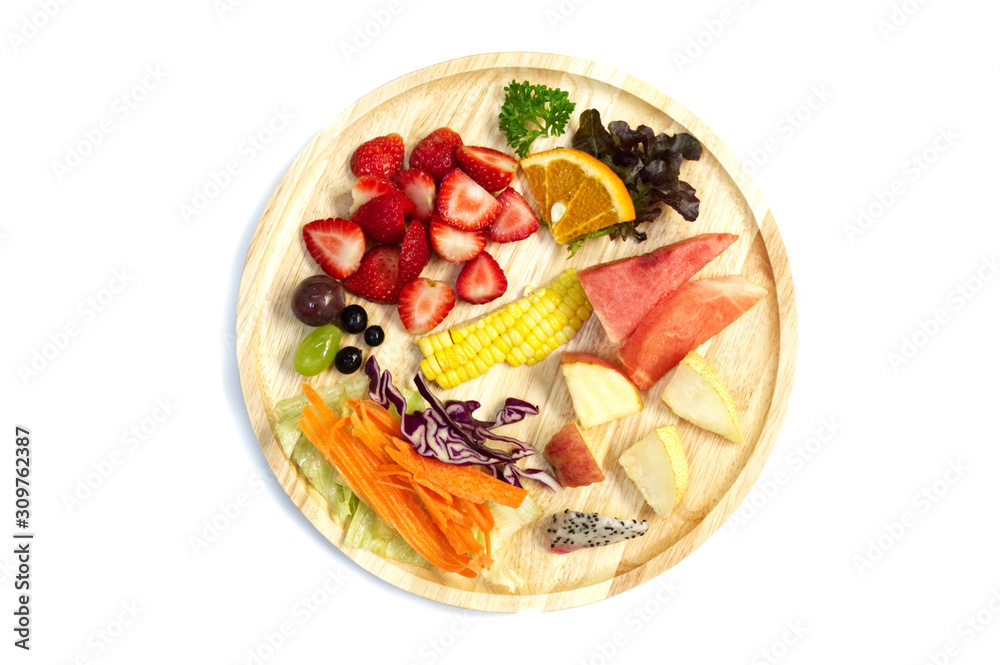 Salad with mixed fruits and vegetable  in wooden plate isolated on white background. copy space.