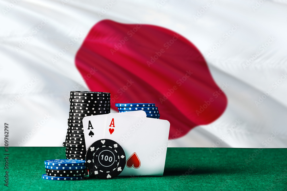 Japan casino theme. Two ace in poker game, cards and black chips on green table with national flag background. Gambling and betting.