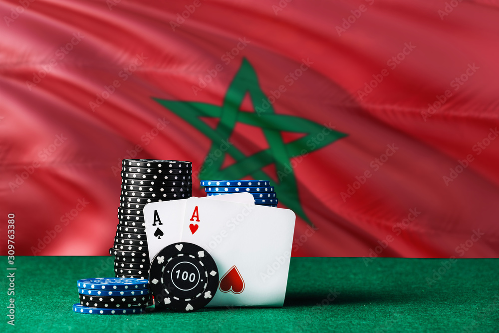 Morocco casino theme. Two ace in poker game, cards and black chips on green table with national flag background. Gambling and betting.