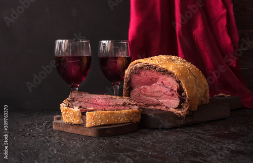 Beef Wellington, a traditional English dish and red wine. Copy space