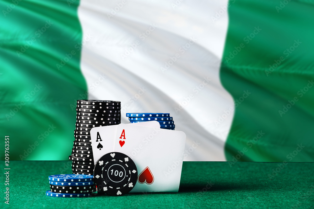 Nigeria casino theme. Two ace in poker game, cards and black chips on green table with national flag background. Gambling and betting.