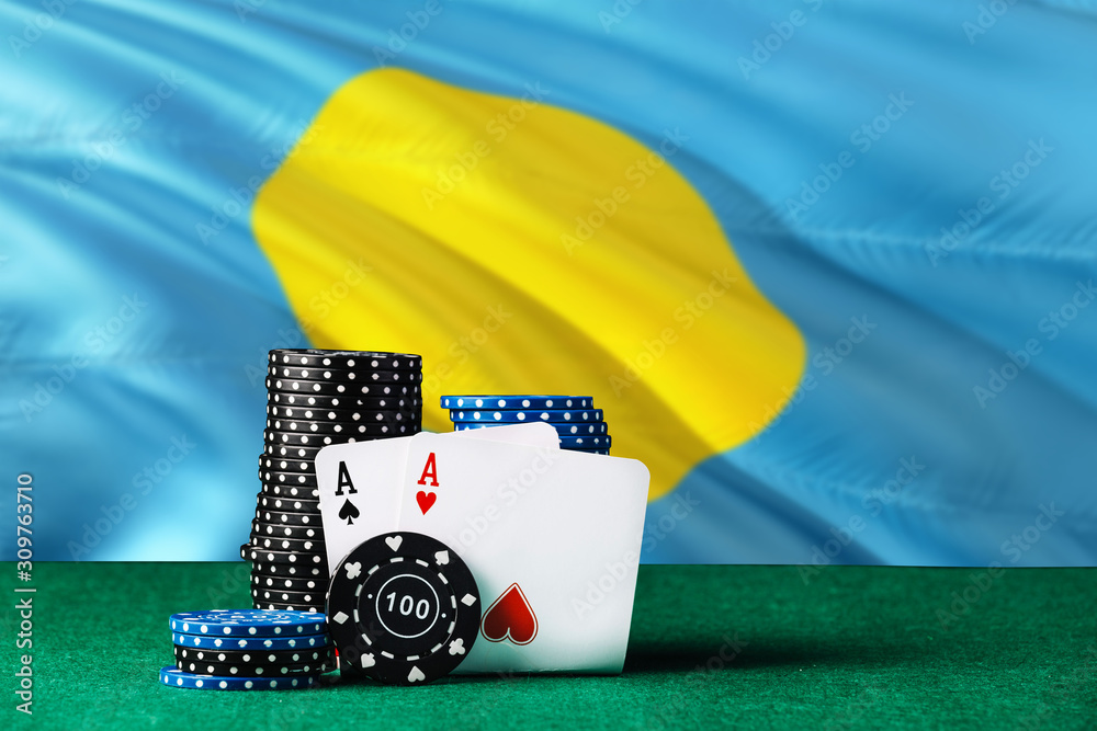 Palau casino theme. Two ace in poker game, cards and black chips on green table with national flag background. Gambling and betting.