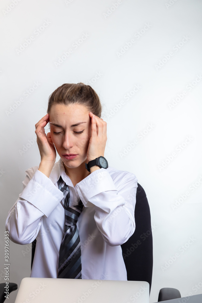 The woman has a headache. Business woman in a white shirt The woman has a headache. Business woman in a white shirt