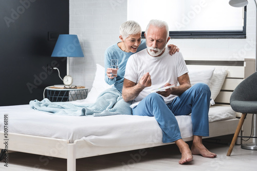 Elderly couple taking medication photo