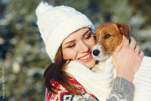Jack Russell Terrier dog with owner woman in the winter outdoors. © bakharev