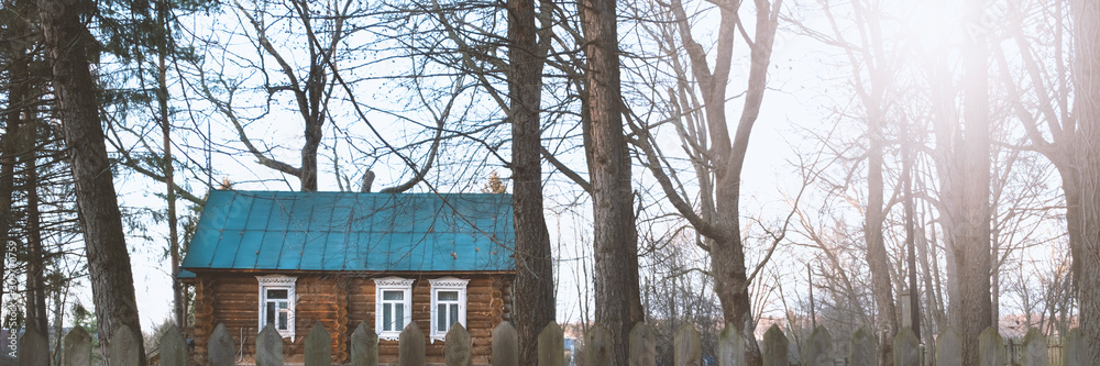 Banner of wooden house with fence in forest during autumn. Nature background