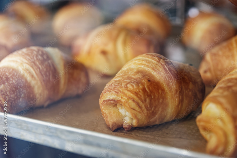 Baking croissants on metal sheet in oven