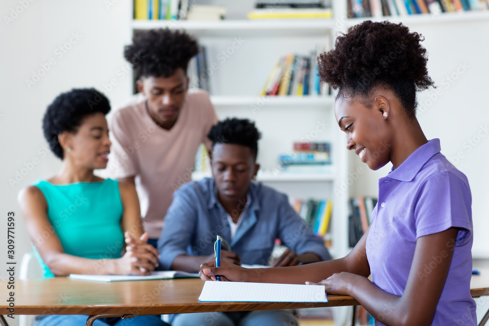 Young african american female student learning at desk at school Young african american female student learning at desk at school