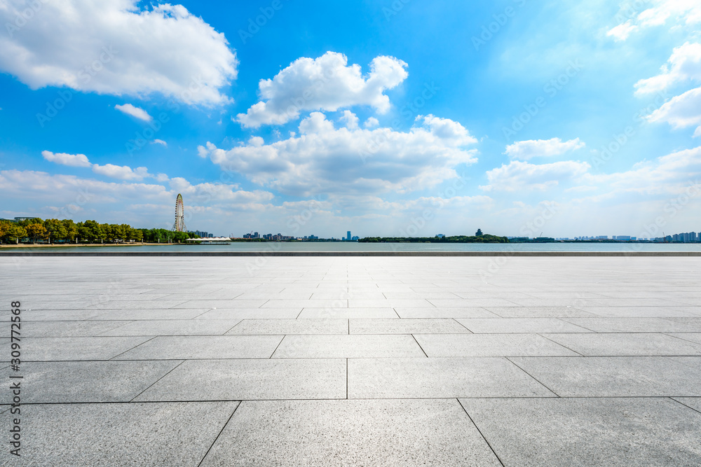 Empty square floor and Suzhou city skyline on a sunny day.
