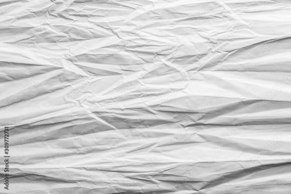 Crumpled sheet of white paper. Textured background.