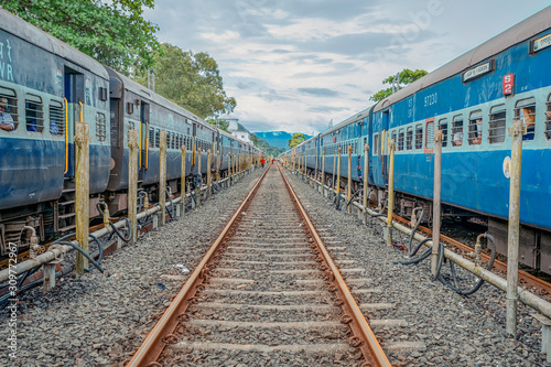 Obraz na płótnie 20/10/2019 India, Maharashtra prospective image of two Indian train with rail between them with gloomy sky. Train to GOA. overpopulation concept w salonie