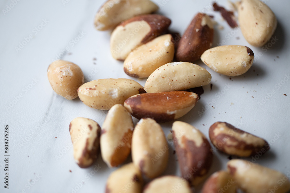 Brazil nuts on white marble background