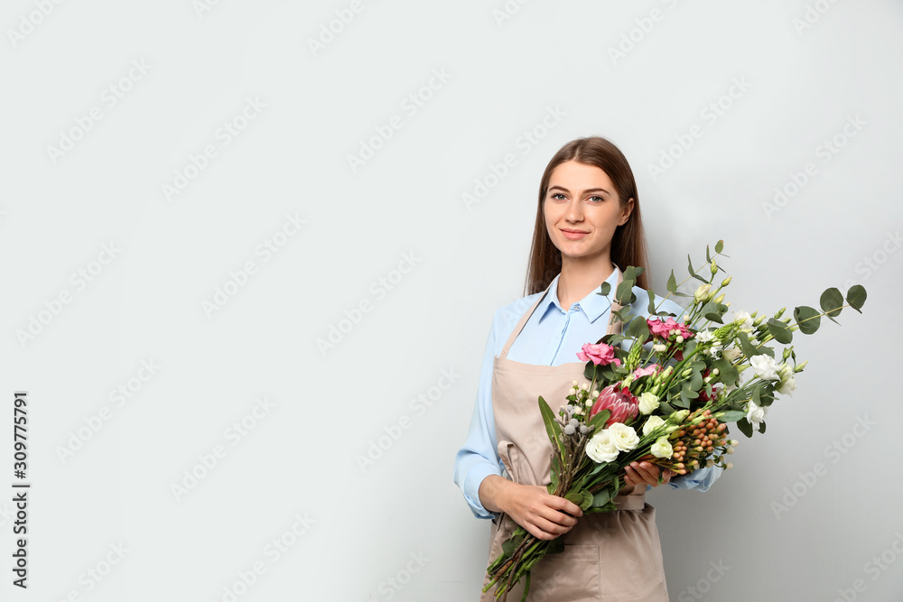 Florist with beautiful bouquet on light background, space for text Florist with beautiful bouquet on light background, space for text