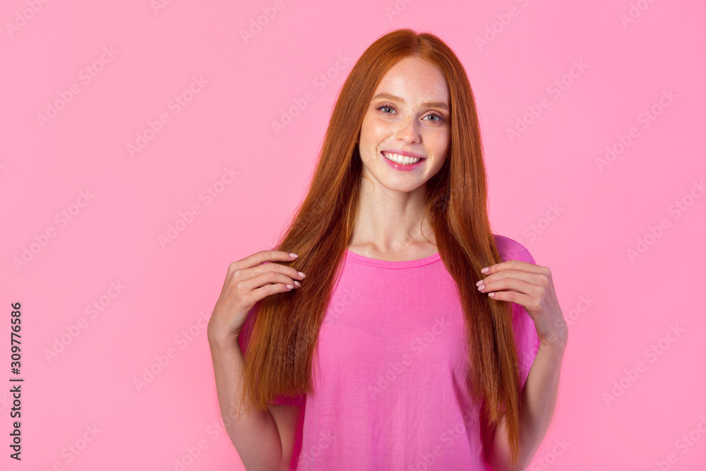 beautiful young woman with red hair on a pink background beautiful young woman with red hair on a pink background