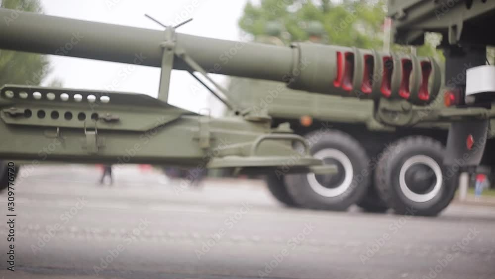 Close-up of the wheels of passing of military vehicles carrying artillery guns at a military parade. Close-up of the wheels of passing of military vehicles carrying artillery guns at a military parade.