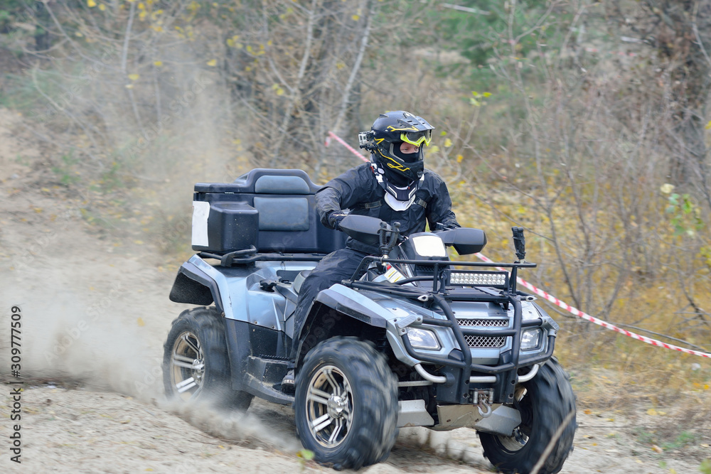 Cool view of active ATV and UTV driving in mud at Autumn Cool view of active ATV and UTV driving in mud at Autumn