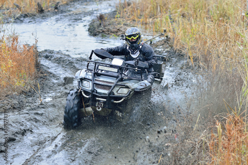 Cool pictures of active ATV driving in mud and water at Autumn weather