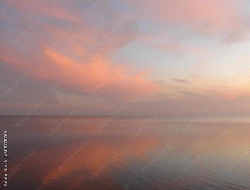 clouds reflected in the sea at sunset