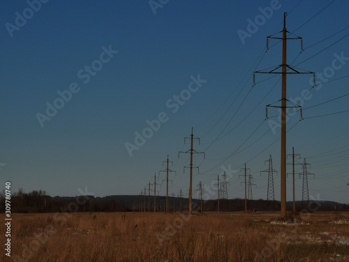 power lines and pylons at sunset