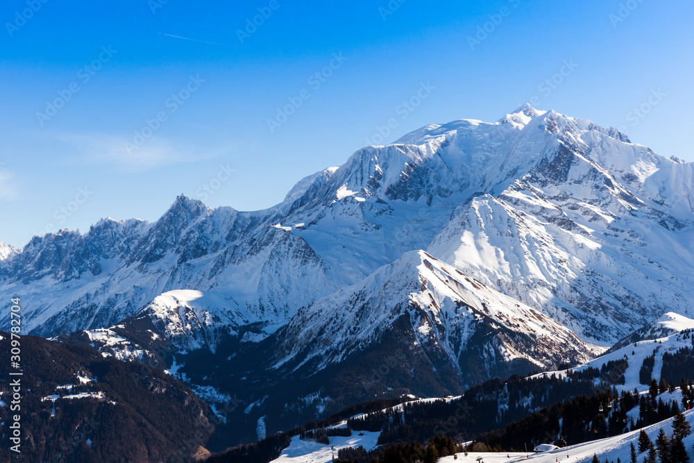 Fototapeta premium Beautiful view from the ski slopes in snow-caped mountains.