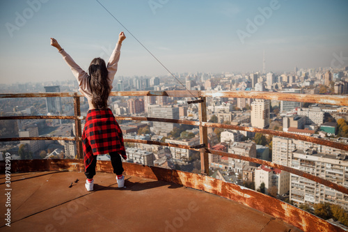 Young woman is standing on the roof